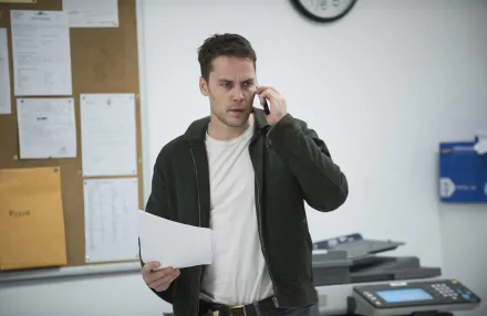 Actor from TV show True Detective, portraying a focused character on a phone call in an office setting, in a high-definition wallpaper background.