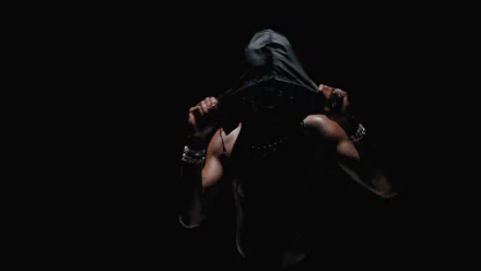 A dark, moody 4K Ultra HD PC desktop wallpaper featuring Playboi Carti with his hood partially covering his face, embodying a mysterious music vibe.