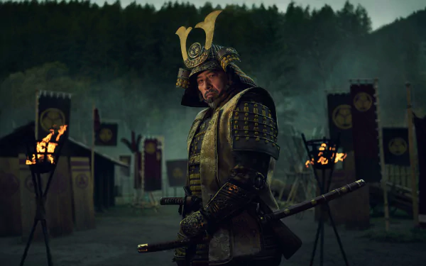 HD Wallpaper featuring a samurai from the 2024 TV show Shogun, dressed in traditional armor, standing solemnly in a dusk-lit encampment with banners and torches in the background.