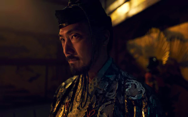 A dramatic HD wallpaper from the TV show Shogun (2024), featuring a character in ornate attire, set against a rich, atmospheric background.