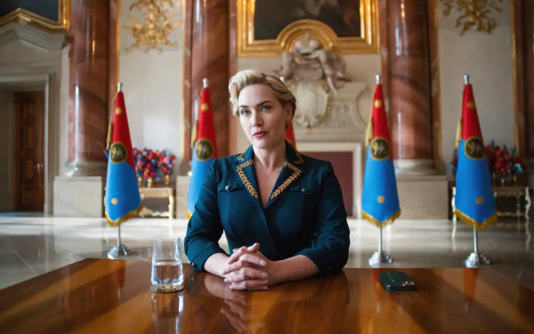 HD desktop wallpaper featuring a scene from the TV show 'The Regime' with a character portrayed by the actress, sitting at an elegant conference table surrounded by flags.