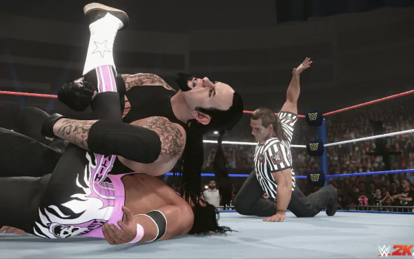 HD desktop wallpaper of WWE 2K24 video game featuring a wrestler performing a pin on an opponent with the referee counting, in a packed arena setting.