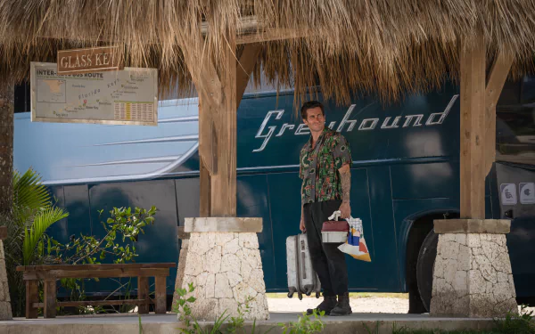 HD wallpaper featuring a scene from the 2024 movie Road House with a character standing in front of a Greyhound bus.