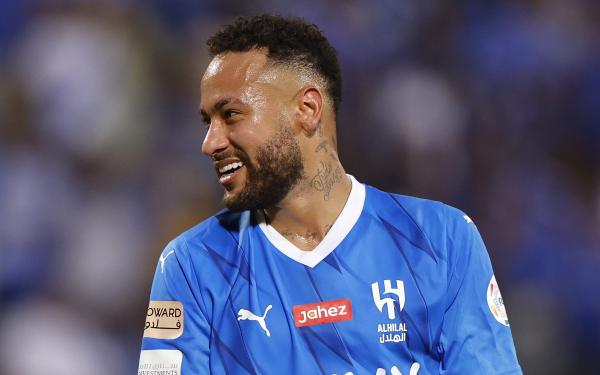 Soccer player in blue jersey smiling on the field, HD desktop wallpaper background