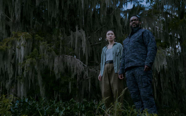 A scene from the TV show 3 Body Problem, featuring two characters standing amidst dense, moss-covered trees, set against a moody, atmospheric backdrop.