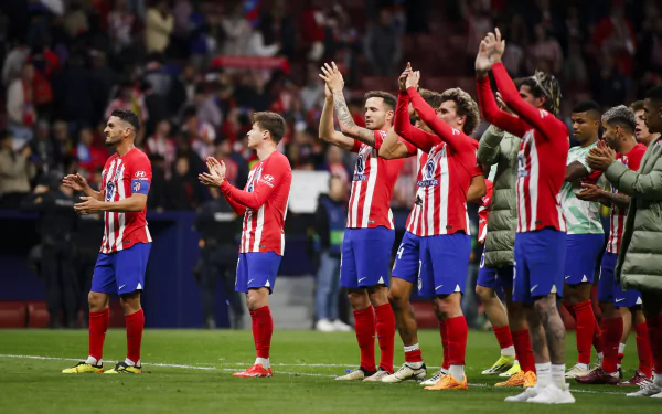 Atlético Madrid players celebrate after a UEFA Champions League match, showcasing team spirit and excitement in this dynamic HD desktop wallpaper.