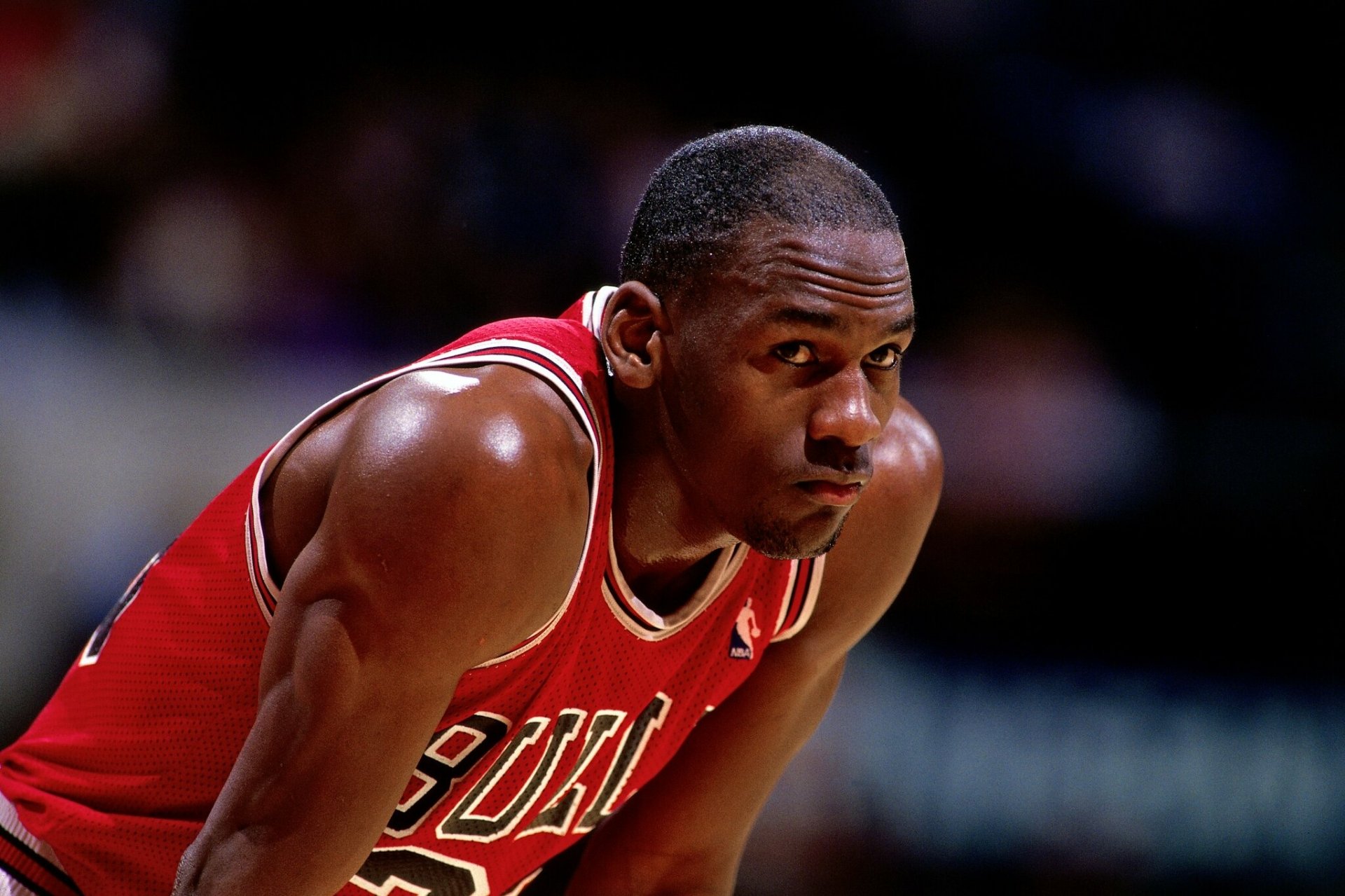 HD desktop wallpaper featuring NBA legend Michael Jordan in a Chicago Bulls uniform, showcasing his determination and focus on the basketball court.