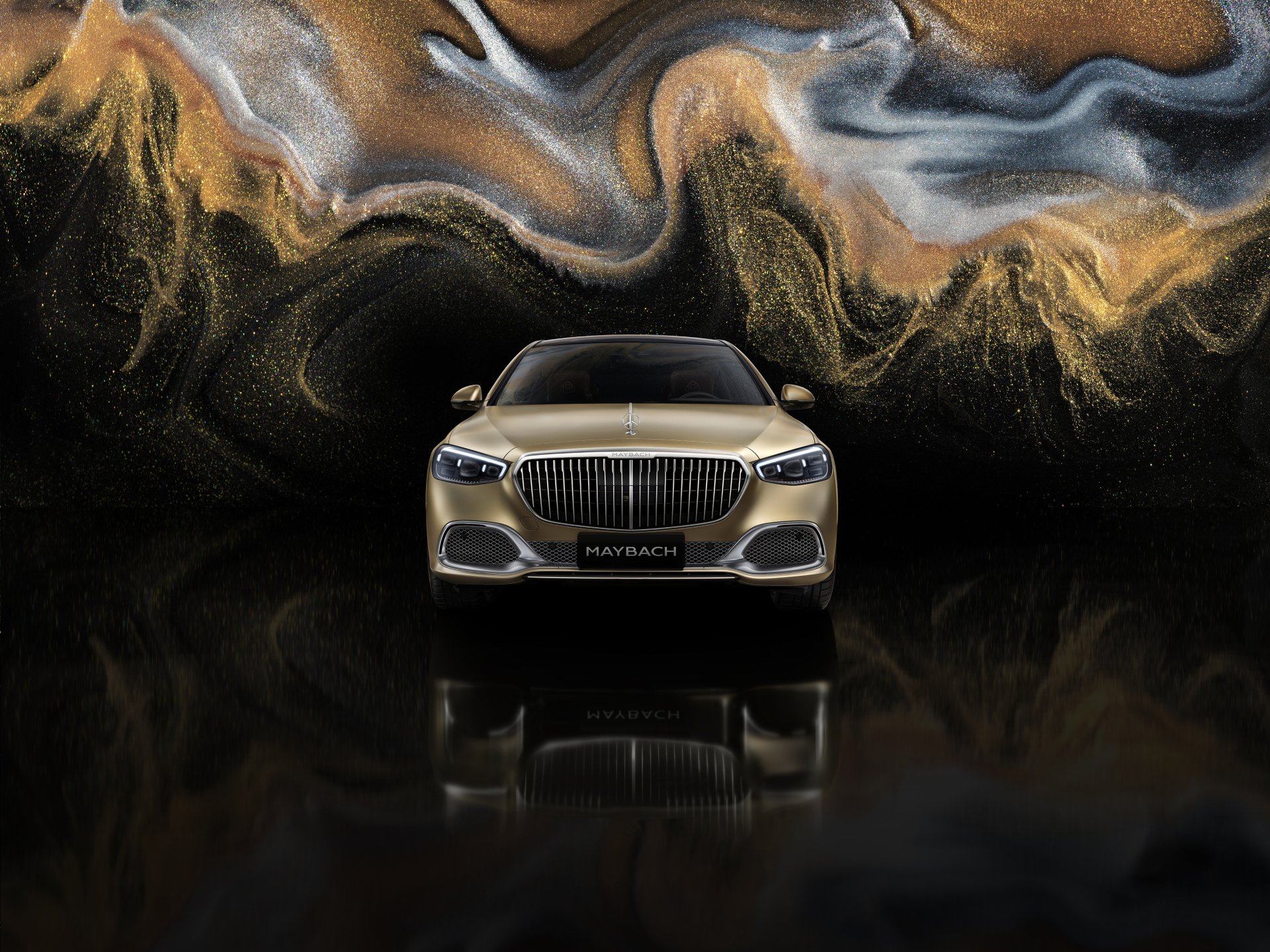 HD desktop wallpaper featuring a front view of a Mercedes-Maybach S 680, set against a vibrant, swirling abstract background.