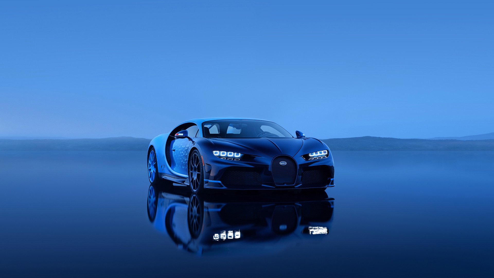HD desktop wallpaper and background featuring a sleek Bugatti Chiron Super Sport in a serene landscape, reflecting its stunning design against a smooth, mirror-like surface.