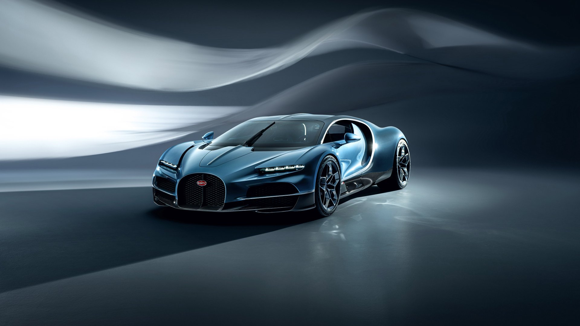 HD desktop wallpaper of a Bugatti Tourbillon car, showcasing the sleek design and luxury features of the vehicle against a modern, fluid background.