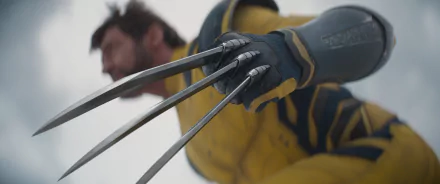 HD desktop wallpaper featuring Wolverine's extended claws in focus, with a blurry background showcasing Wolverine's face, themed around the Deadpool & Wolverine movie.