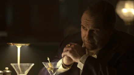 HD desktop wallpaper of Colin Farrell as The Penguin from a TV show, depicted in a dimly lit setting with martinis in the background.