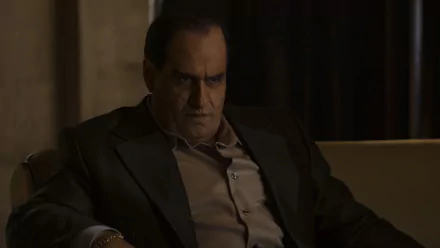 HD desktop wallpaper featuring Colin Farrell as The Penguin in a TV show, depicted sitting pensively in a darkly lit room.