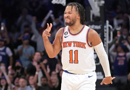 Jalen Brunson in New York Knicks jersey, celebrating on the court with fans cheering in the background. A dynamic HD wallpaper for NBA and Knicks enthusiasts.
