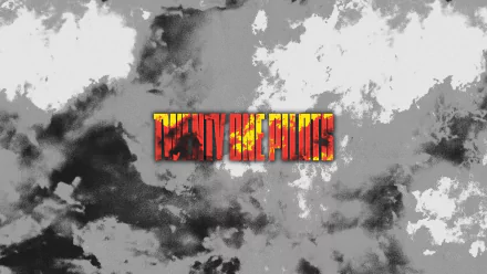 HD PC desktop wallpaper featuring the Twenty One Pilots logo in bold red and yellow against a textured black and white cloudy background.