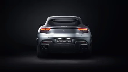HD desktop wallpaper featuring the sleek rear view of a Ferrari Purosangue against a dark background, showcasing its elegant design and distinct taillights.