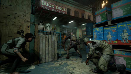 HD wallpaper from The Outlast Trials video game, depicting characters in a tense confrontation in a gritty toy factory setting, with Duck Duck Toy Factory signage in the background.