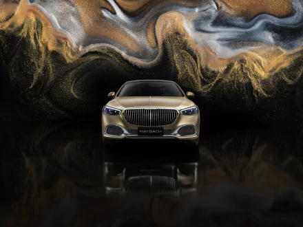 HD desktop wallpaper featuring a front view of a Mercedes-Maybach S 680, set against a vibrant, swirling abstract background.