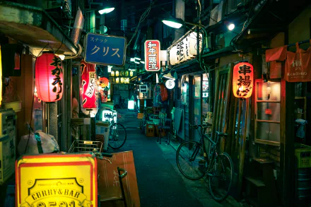 A vibrant night street in Tokyo, Japan, adorned with colorful signs and lanterns. The image captures the essence of a bustling city, creating a captivating HD desktop wallpaper and background.