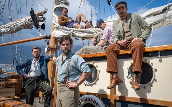 HD desktop wallpaper featuring characters from The Ministry of Ungentlemanly Warfare movie posed on a sailboat.