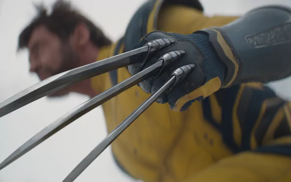 HD desktop wallpaper featuring Wolverine's extended claws in focus, with a blurry background showcasing Wolverine's face, themed around the Deadpool & Wolverine movie.