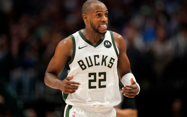 HD desktop wallpaper featuring Khris Middleton of the Milwaukee Bucks in action on the basketball court, wearing his white Bucks jersey.