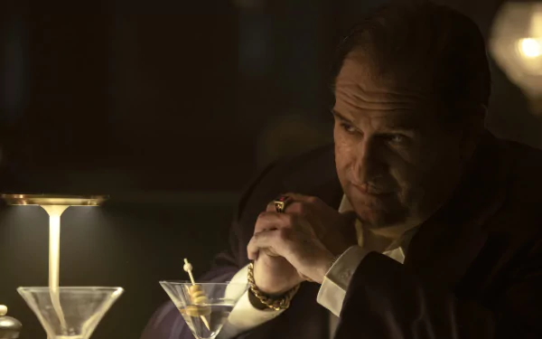 HD desktop wallpaper of Colin Farrell as The Penguin from a TV show, depicted in a dimly lit setting with martinis in the background.
