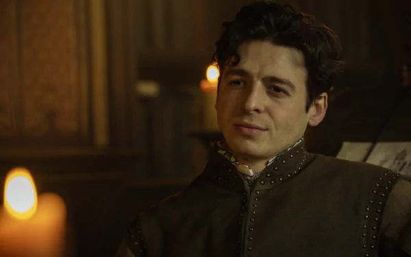 HD desktop wallpaper featuring a character from the TV show Shardlake in a historical costume, seated in a dimly lit room with candles.