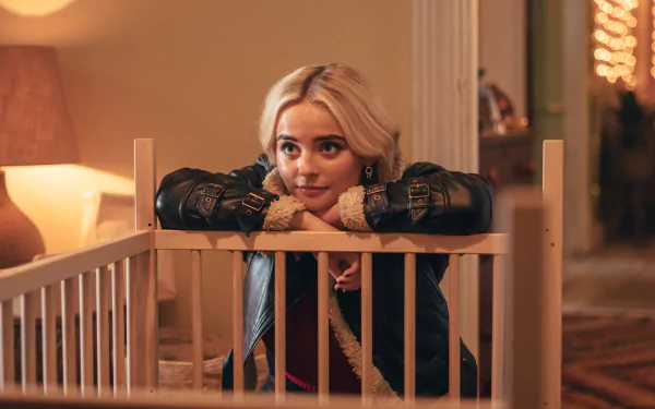 HD desktop wallpaper featuring a scene from Doctor Who (2023), with a young woman leaning on a crib, immersed in a warmly lit room.