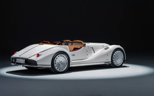 HD wallpaper featuring a sleek, white Morgan Midsummer car, elegantly illuminated against a dark background.