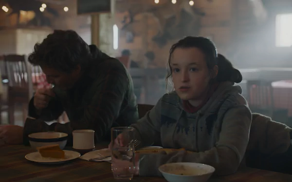 Two weary survivors at a dim diner table with bowls and mugs, moody scene from The Last Of Us — 8K Ultra HD PC desktop wallpaper and background.