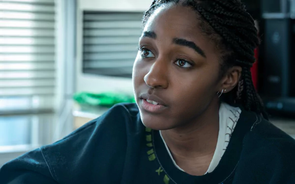 HD desktop wallpaper and background featuring a character from the TV show The Bear, showcasing a young woman with braided hair and a contemplative expression in a softly lit interior setting.