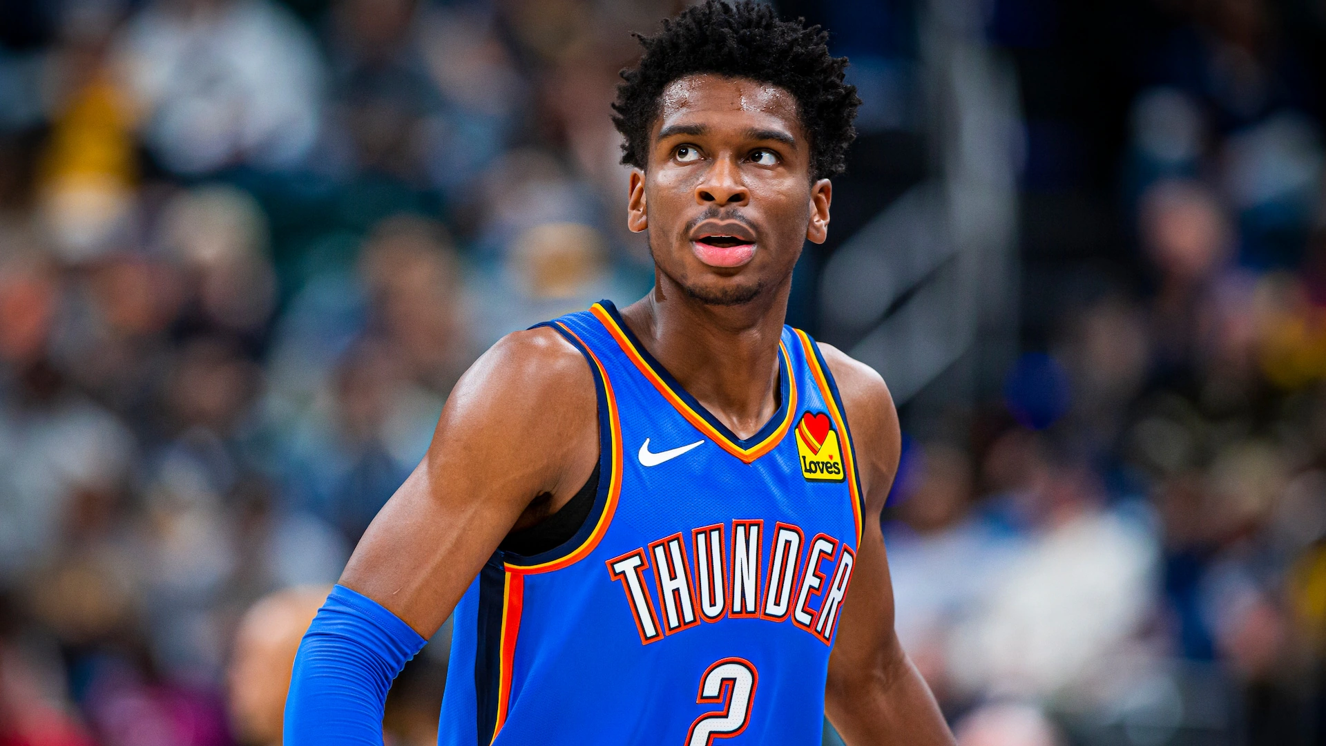 Shai Gilgeous-Alexander of the Oklahoma City Thunder is featured in this HD basketball wallpaper, capturing his focus during an NBA game.