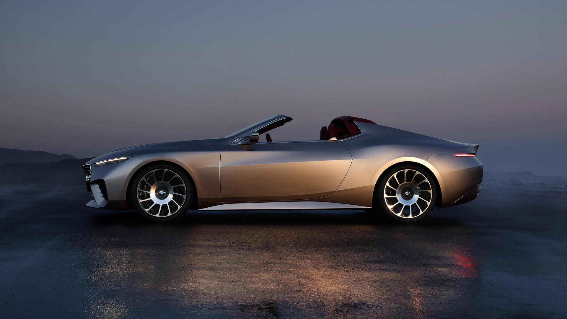 Side view of a sleek BMW Skytop convertible, highlighted by its modern design and stylish wheels, set against a serene backdrop. A stunning 4K Ultra HD desktop wallpaper.