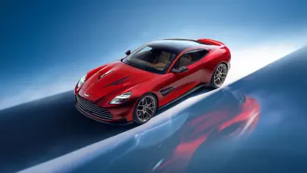 A stunning Aston Martin Vanquish in vibrant red, showcased against a sleek blue background. This 4K Ultra HD image highlights the car's elegant design and powerful stance.