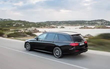 A high-definition desktop wallpaper featuring a sleek Mercedes-Benz E43 AMG, showcasing the luxury and performance of the Mercedes-Benz AMG lineup.