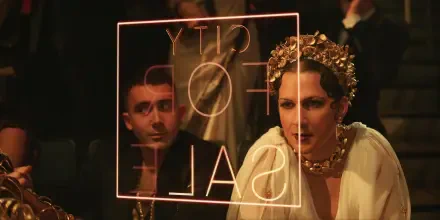 A scene from the movie Megalopolis (2024) featuring Shia LaBeouf, showcasing characters deep in thought with a backdrop displaying CITY FOR SALE. An HD desktop wallpaper.