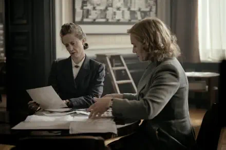 Two women sitting at a table, examining documents in a historical setting. A scene from the movie Lee (2023), captured in 4K Ultra HD for a desktop wallpaper.
