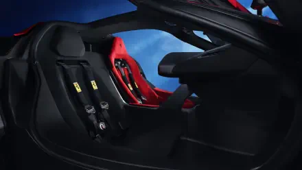 Close-up view of the interior of a Ferrari F80, showcasing sleek black and red design elements, featuring racing seats and a modern dashboard. 4K Ultra HD PC wallpaper and background.