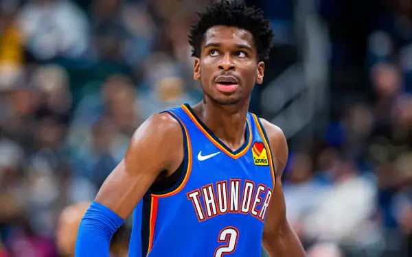 Shai Gilgeous-Alexander of the Oklahoma City Thunder is featured in this HD basketball wallpaper, capturing his focus during an NBA game.