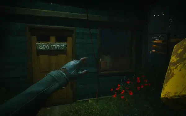 A dark and atmospheric HD desktop wallpaper from the video game A Quiet Place: The Road Ahead, featuring a hand reaching toward a radio station door amidst ominous surroundings.