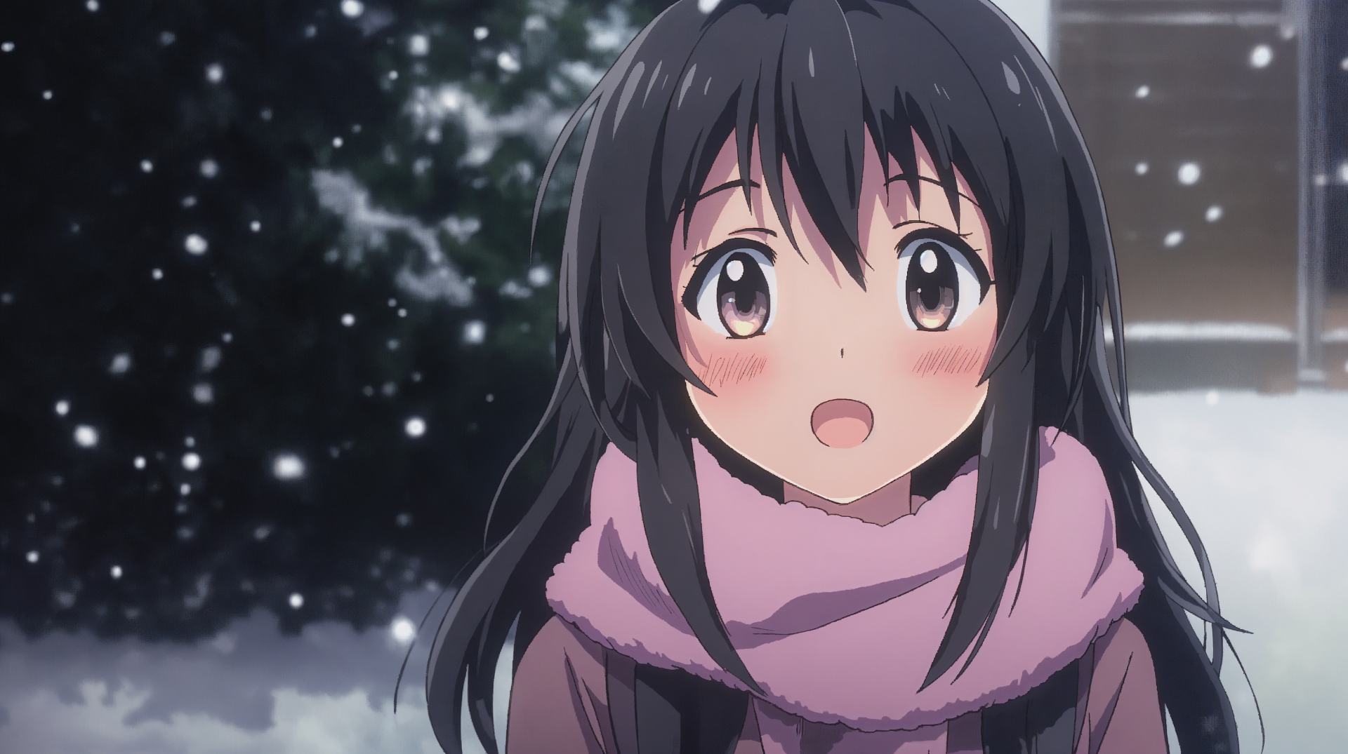 A cheerful anime girl with long black hair smiles warmly, bundled in a pink scarf, as snowflakes fall around her in a serene winter setting. 4K Ultra HD wallpaper background.
