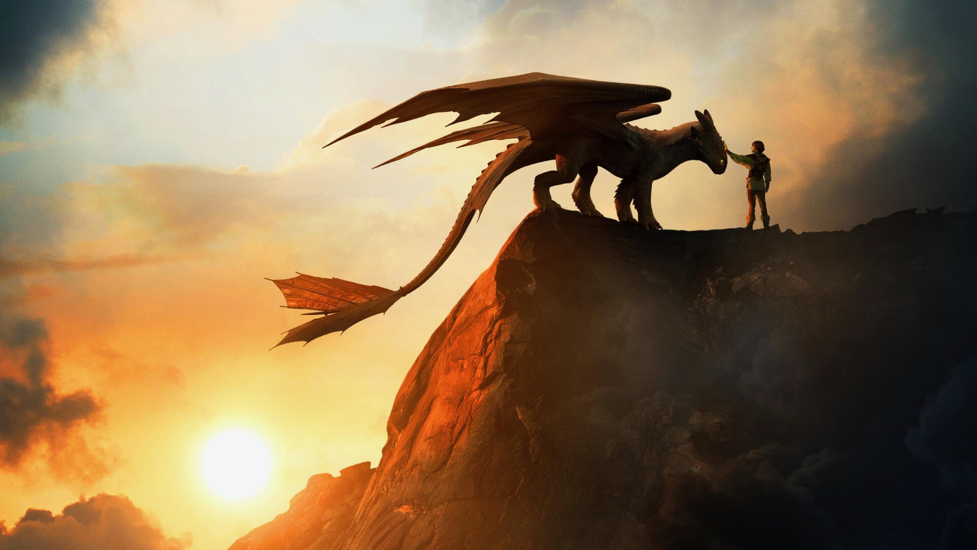 How to Train Your Dragon (2025) 2K Quad HD wallpaper: silhouetted dragon and rider meet on a cliff at sunset.