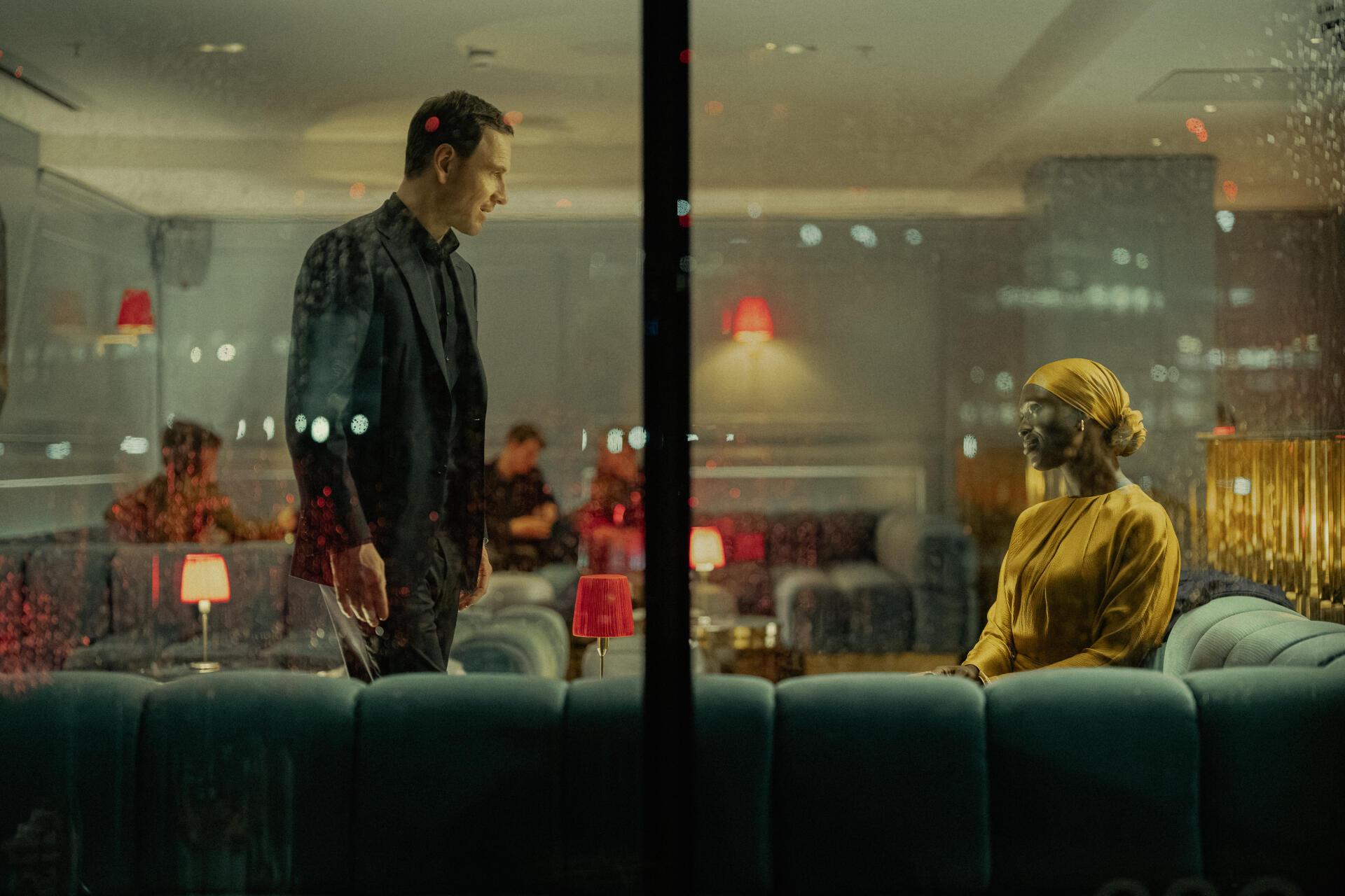 A striking scene from the TV show The Agency, featuring Michael Fassbender in a tense conversation. The 8K Ultra HD wallpaper captures the dramatic ambiance beautifully.