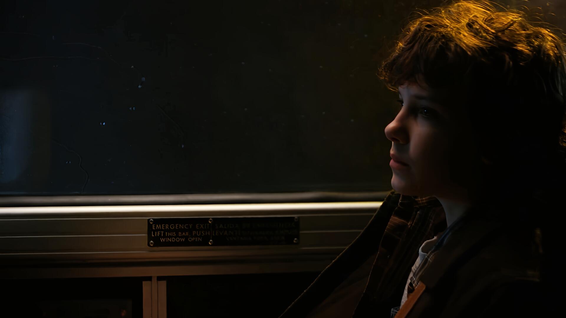 HD desktop wallpaper featuring Eleven from Stranger Things, portrayed by Millie Bobby Brown, in a dark, contemplative profile shot.