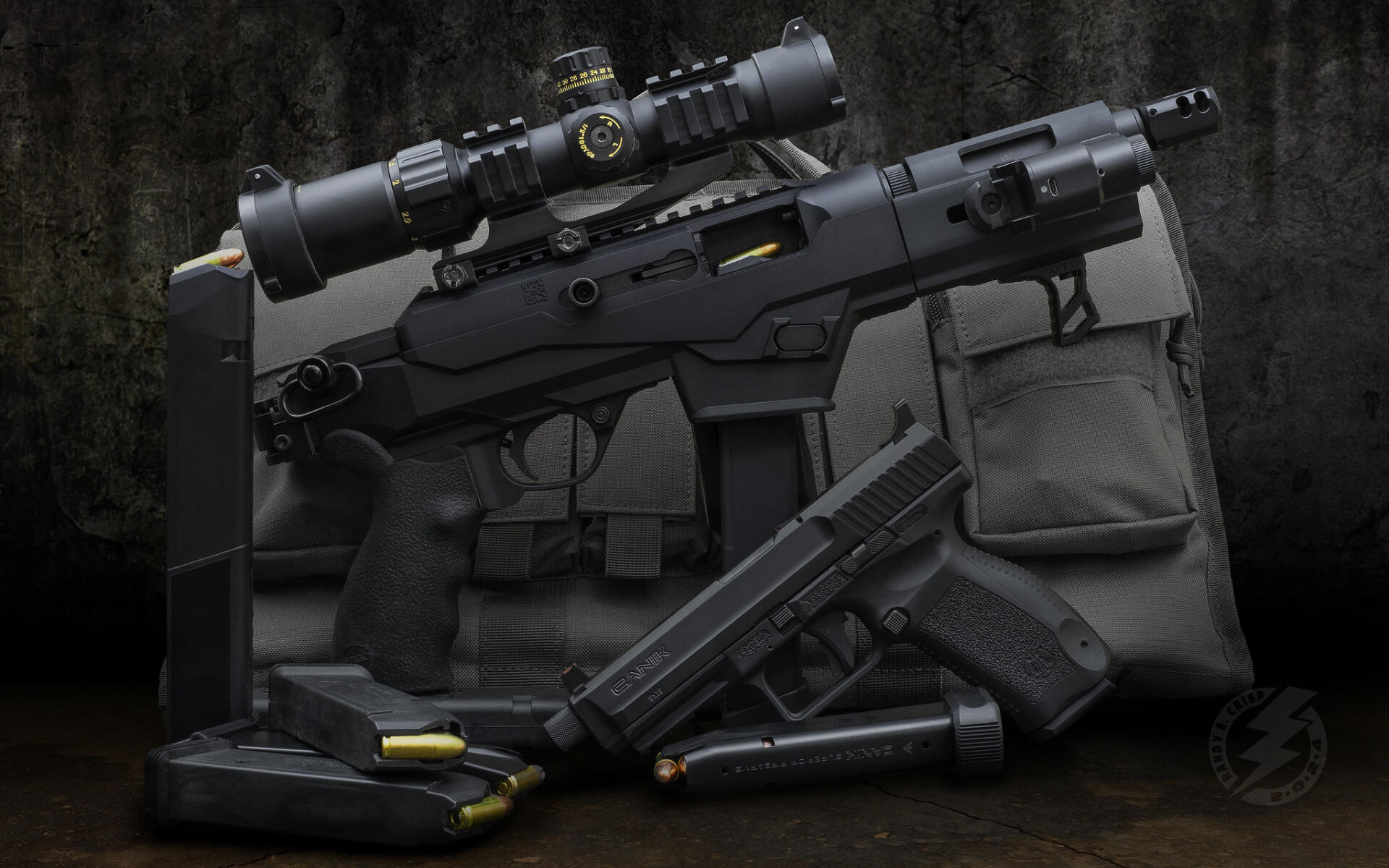 HD PC desktop wallpaper background showing guns: a scoped rifle, pistol, magazines and scattered rounds on a tactical bag against a dark, worn backdrop.