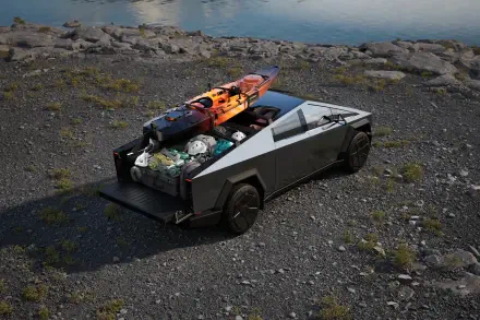 A Tesla Cybertruck parked on rocky terrain with a kayak and gear in its bed, showcasing its spacious design and rugged appeal in a stunning 4K Ultra HD setting.