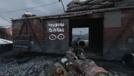A scene from Metro Exodus featuring a character holding a weapon, standing in front of a weathered building with graffiti. The gritty ambiance captures the game's post-apocalyptic setting.