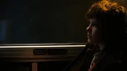 HD desktop wallpaper featuring Eleven from Stranger Things, portrayed by Millie Bobby Brown, in a dark, contemplative profile shot.