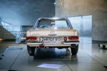 A classic Mercedes-Benz 230 SL showcased in a modern setting, featuring a clean design and distinctive rear view, serves as a striking 4K Ultra HD desktop wallpaper.